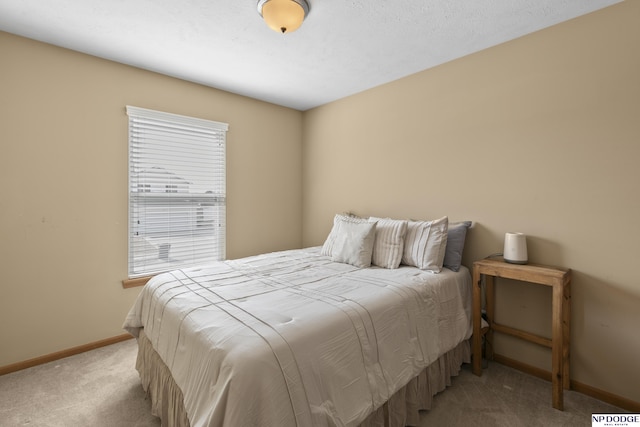 bedroom featuring baseboards and carpet floors