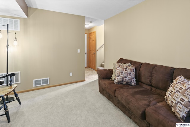 carpeted living room featuring visible vents, baseboards, and stairway