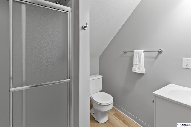 full bathroom with vanity, wood finished floors, baseboards, a shower stall, and toilet