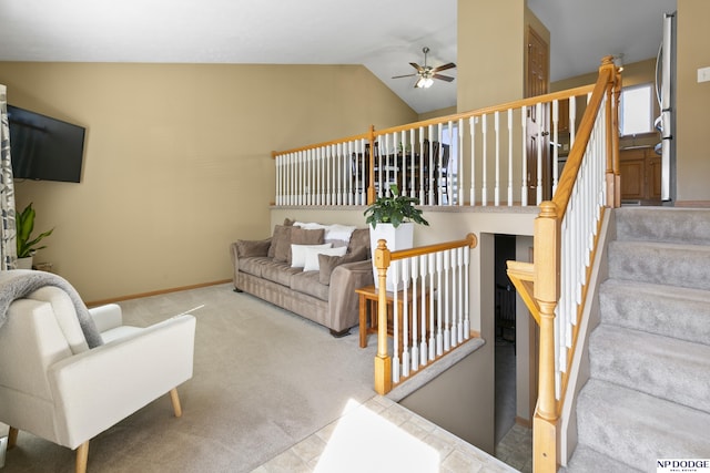 living room with baseboards, carpet floors, ceiling fan, stairs, and vaulted ceiling