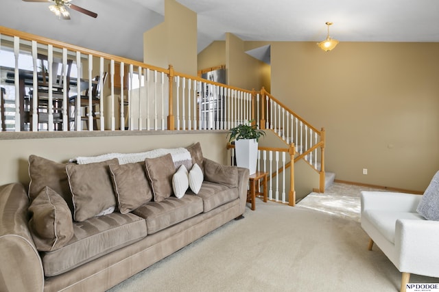 carpeted living room with lofted ceiling, stairway, a ceiling fan, and baseboards