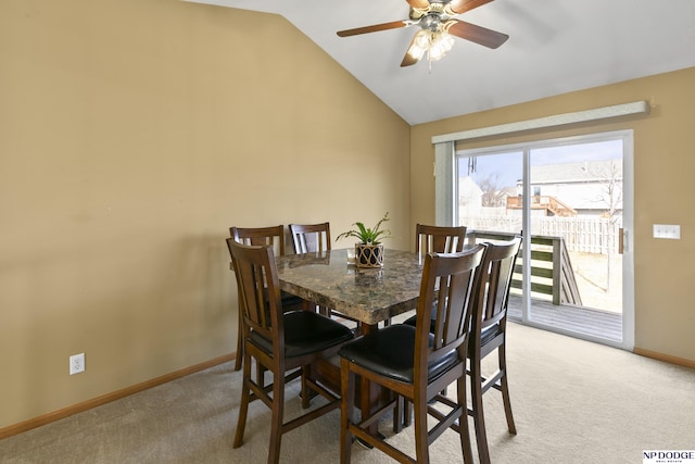 dining area with baseboards, lofted ceiling, light colored carpet, and ceiling fan