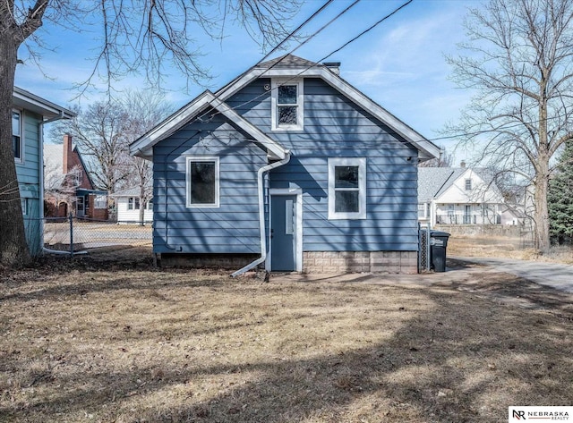 rear view of house with fence