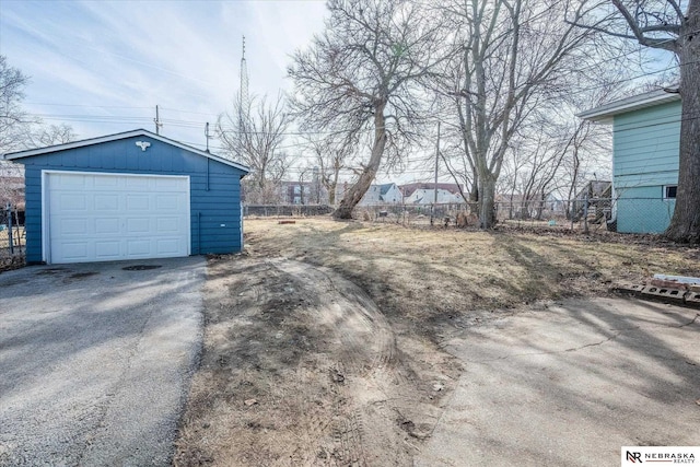 exterior space featuring aphalt driveway and fence