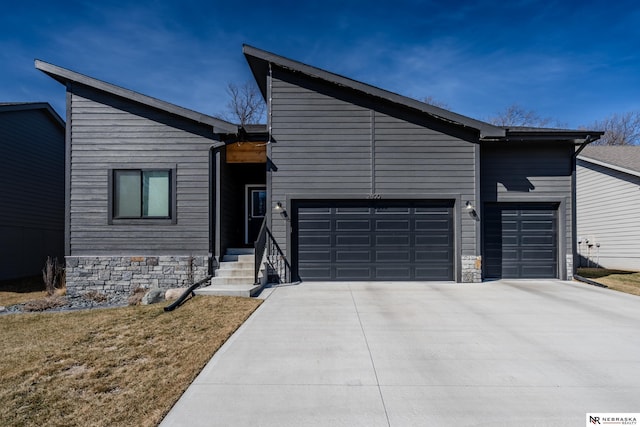 view of front facade with concrete driveway and an attached garage