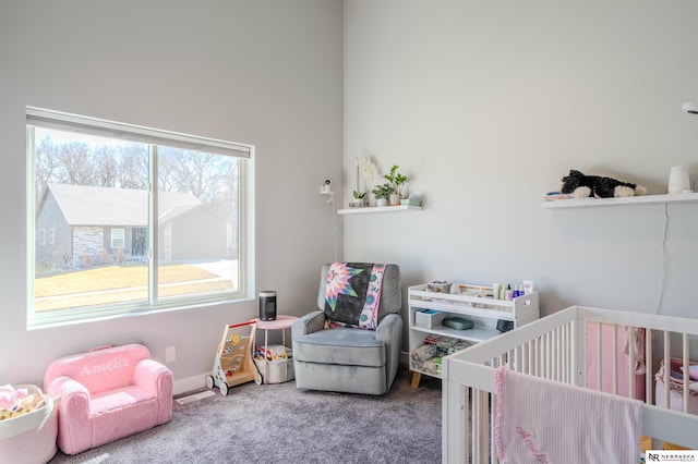 carpeted bedroom featuring a crib