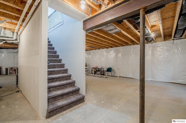 unfinished basement featuring stairway