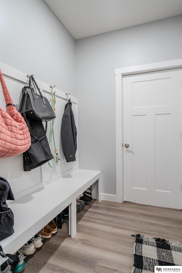 mudroom featuring baseboards and light wood-style floors