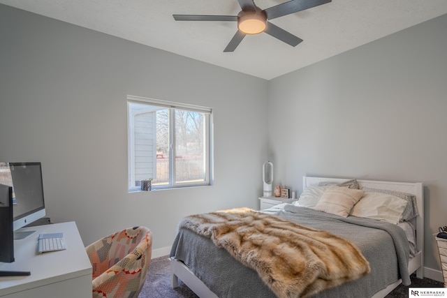 carpeted bedroom with a ceiling fan and baseboards