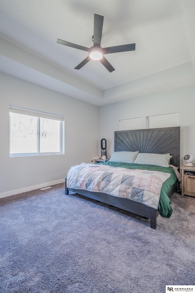 carpeted bedroom with baseboards and ceiling fan