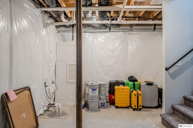 unfinished basement featuring stairs