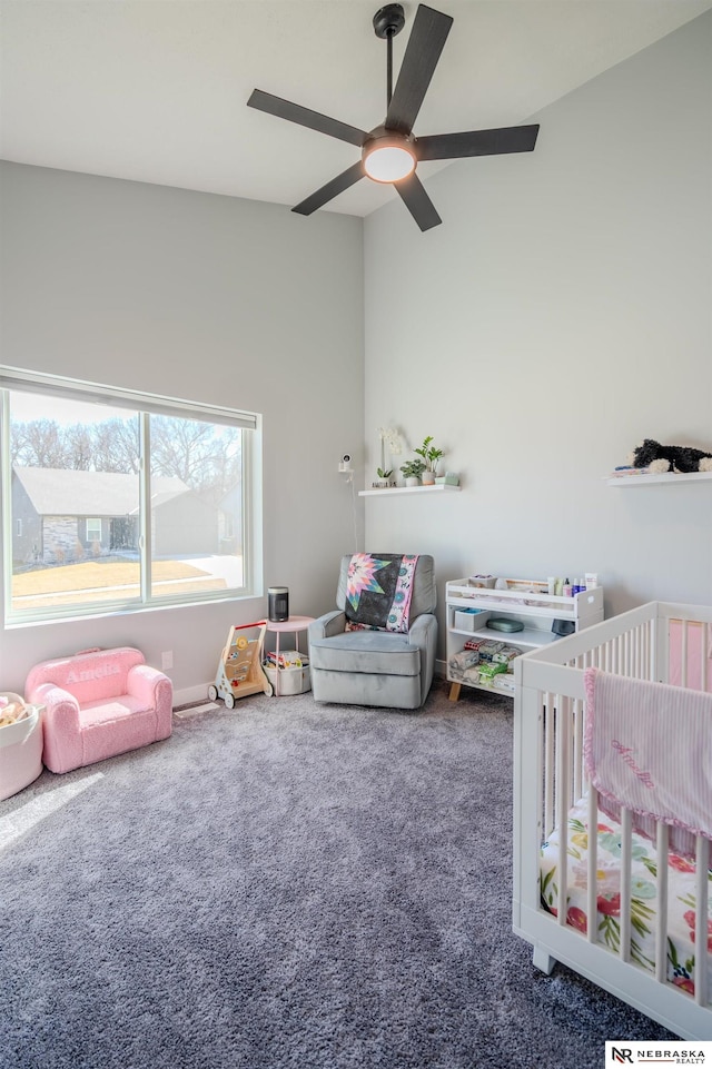 bedroom featuring a crib, carpet floors, and ceiling fan