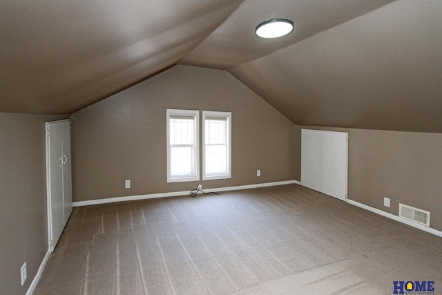 bonus room with visible vents, carpet floors, baseboards, and vaulted ceiling