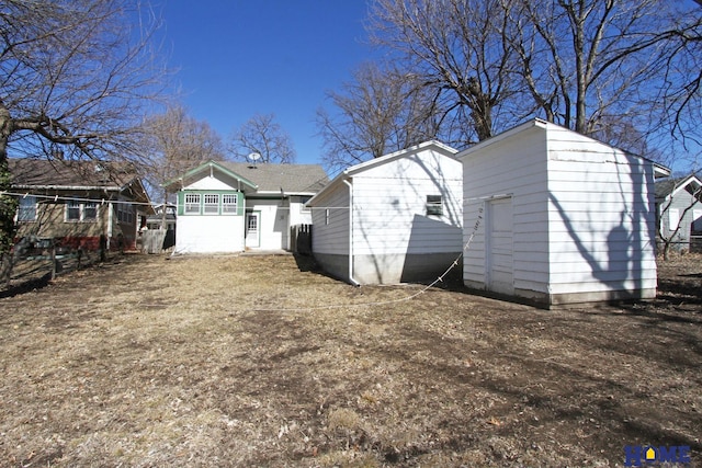 rear view of house with an outdoor structure