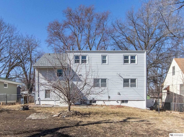 rear view of house with fence