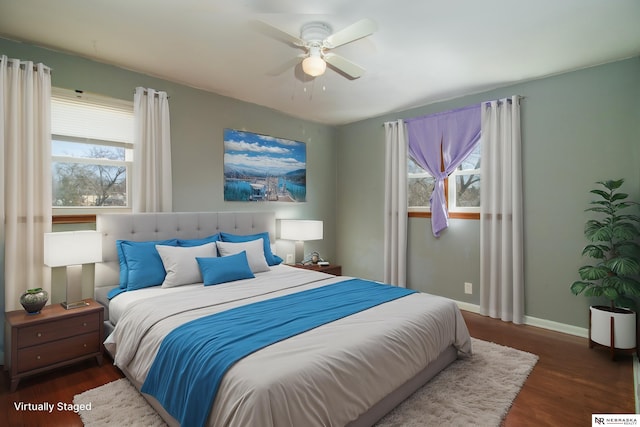 bedroom featuring wood finished floors, baseboards, and ceiling fan