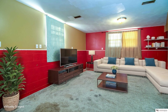 living area with visible vents and carpet flooring