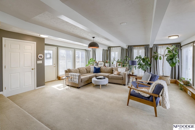 living room featuring visible vents, beam ceiling, light colored carpet, and a textured ceiling