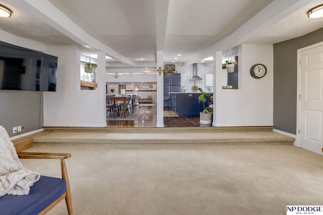 living room featuring recessed lighting, baseboards, carpet floors, and a textured ceiling