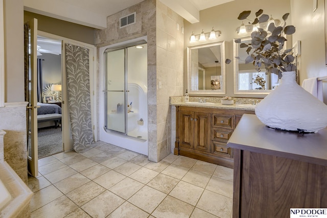 ensuite bathroom featuring tile patterned flooring, tile walls, visible vents, and connected bathroom