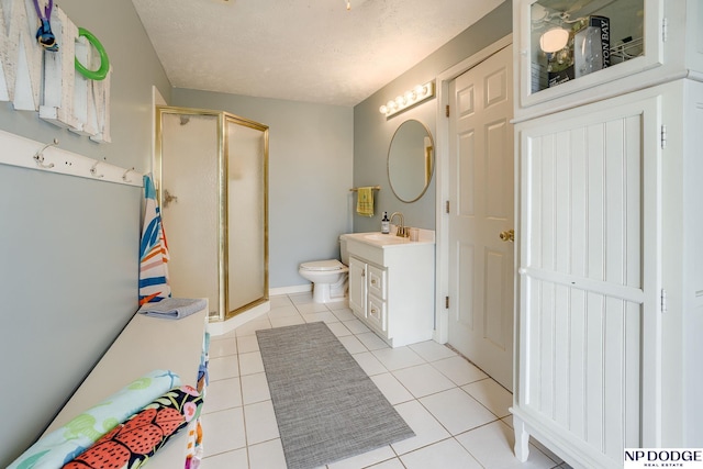 bathroom with vanity, tile patterned floors, toilet, and a shower stall