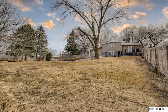 view of yard with a storage shed, an outdoor structure, and fence