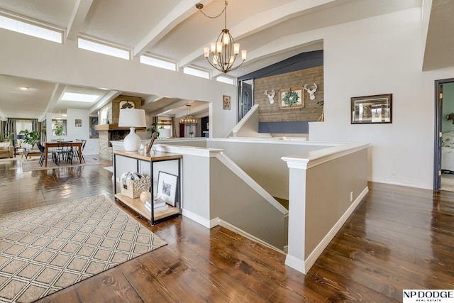 interior space featuring a notable chandelier, wood finished floors, and a large fireplace