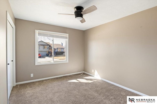 unfurnished bedroom featuring a closet, baseboards, carpet, and a ceiling fan