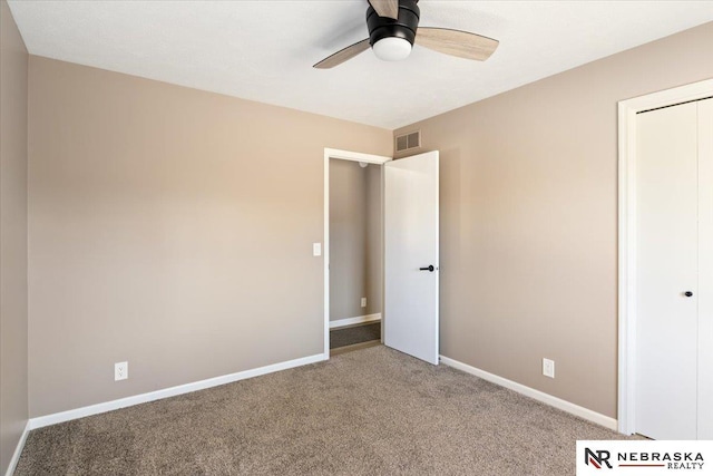 unfurnished bedroom featuring a closet, visible vents, carpet flooring, and baseboards