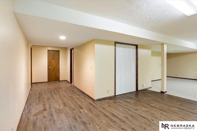 interior space with recessed lighting, wood finished floors, baseboards, and a textured ceiling