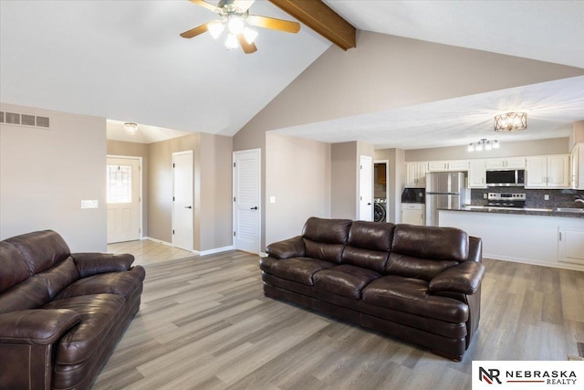 living area with beam ceiling, light wood-style flooring, washer / clothes dryer, and visible vents