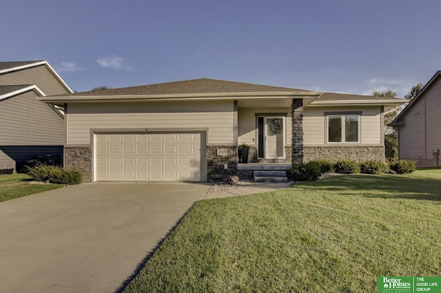 prairie-style house featuring stone siding, an attached garage, driveway, and a front lawn