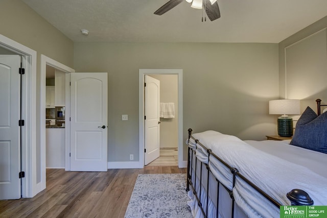 bedroom featuring baseboards, wood finished floors, and a ceiling fan