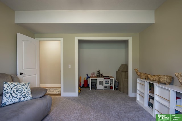 living area with baseboards and carpet floors