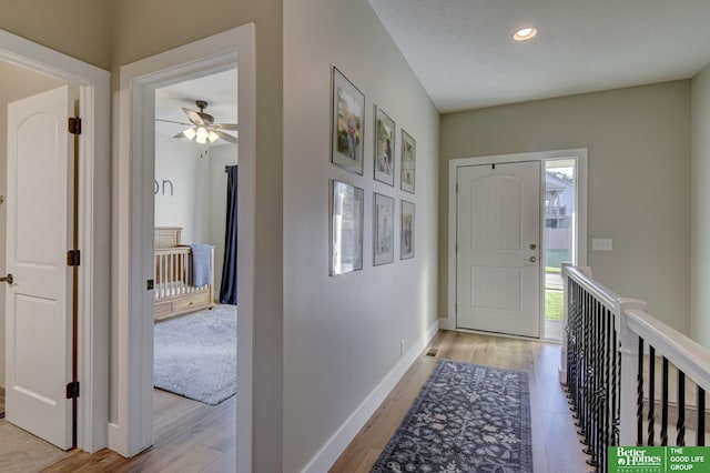 foyer entrance with recessed lighting, baseboards, and light wood-style flooring