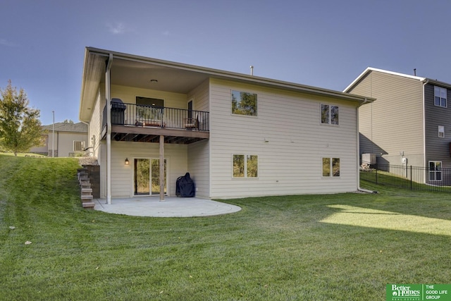 rear view of house featuring a balcony, fence, a patio area, and a lawn