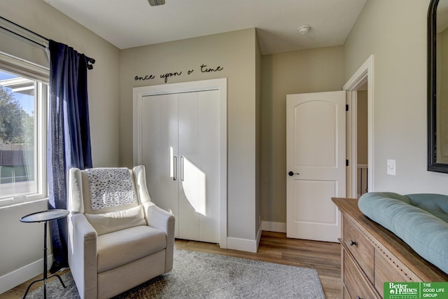 sitting room featuring baseboards and wood finished floors