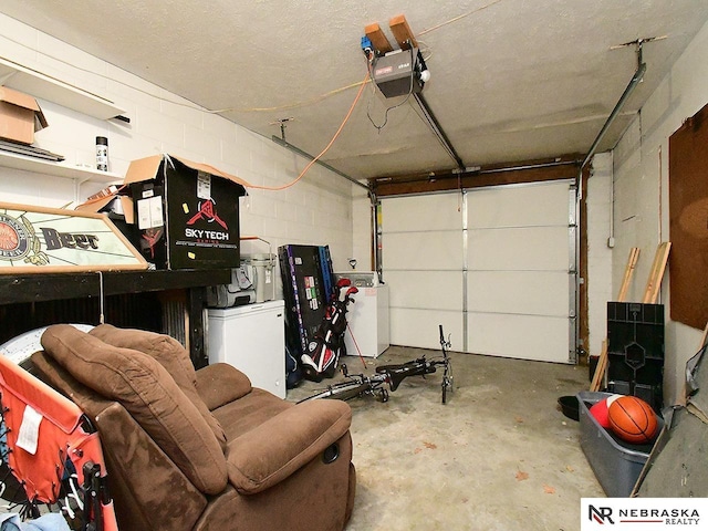 garage with fridge, concrete block wall, and a garage door opener