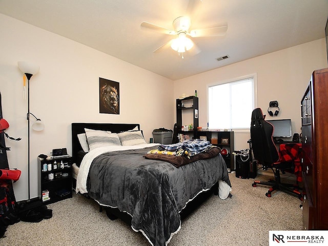 carpeted bedroom featuring visible vents and ceiling fan