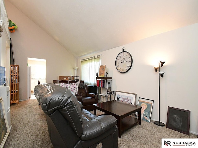 carpeted living area featuring vaulted ceiling