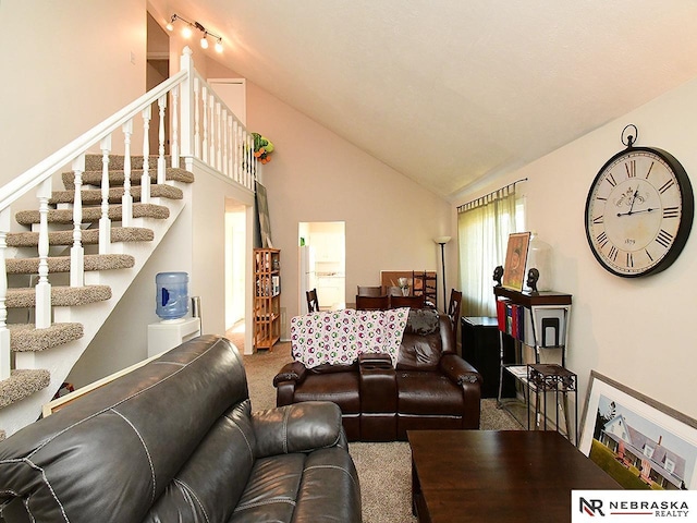 living room featuring stairway, carpet floors, and high vaulted ceiling