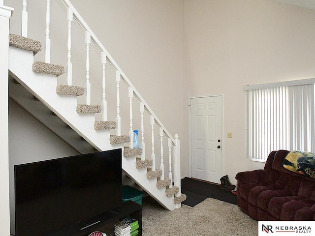 staircase with a towering ceiling