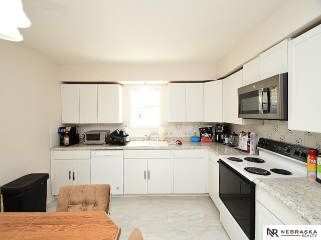 kitchen featuring a sink, electric range oven, white cabinets, dishwasher, and stainless steel microwave