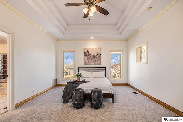 carpeted bedroom featuring visible vents, crown molding, a raised ceiling, and baseboards