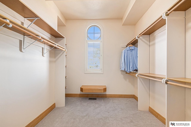 spacious closet with visible vents and light carpet