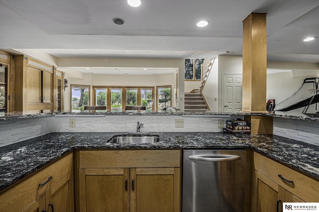 kitchen with tasteful backsplash, brown cabinets, and a sink