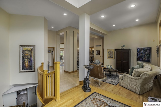 living area with recessed lighting, visible vents, and wood finished floors