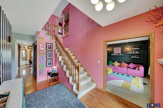 stairway with wood finished floors and baseboards