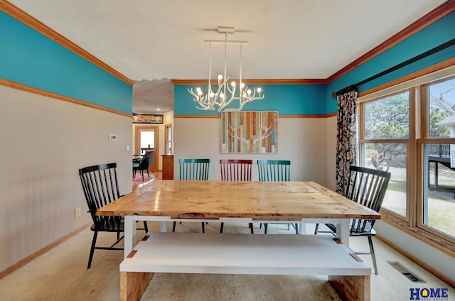 carpeted dining space with crown molding, a notable chandelier, visible vents, and baseboards