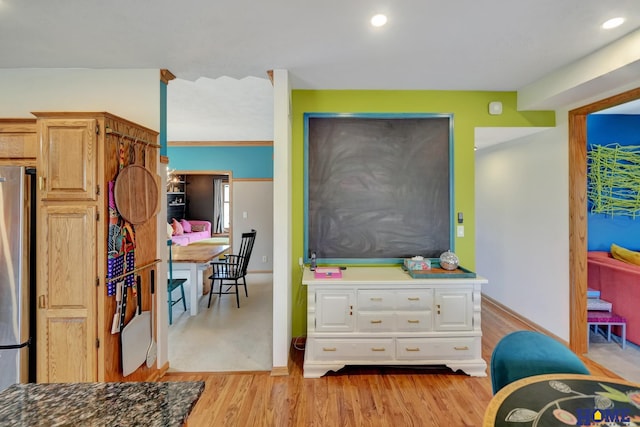 bedroom with recessed lighting, baseboards, light wood-style floors, and freestanding refrigerator